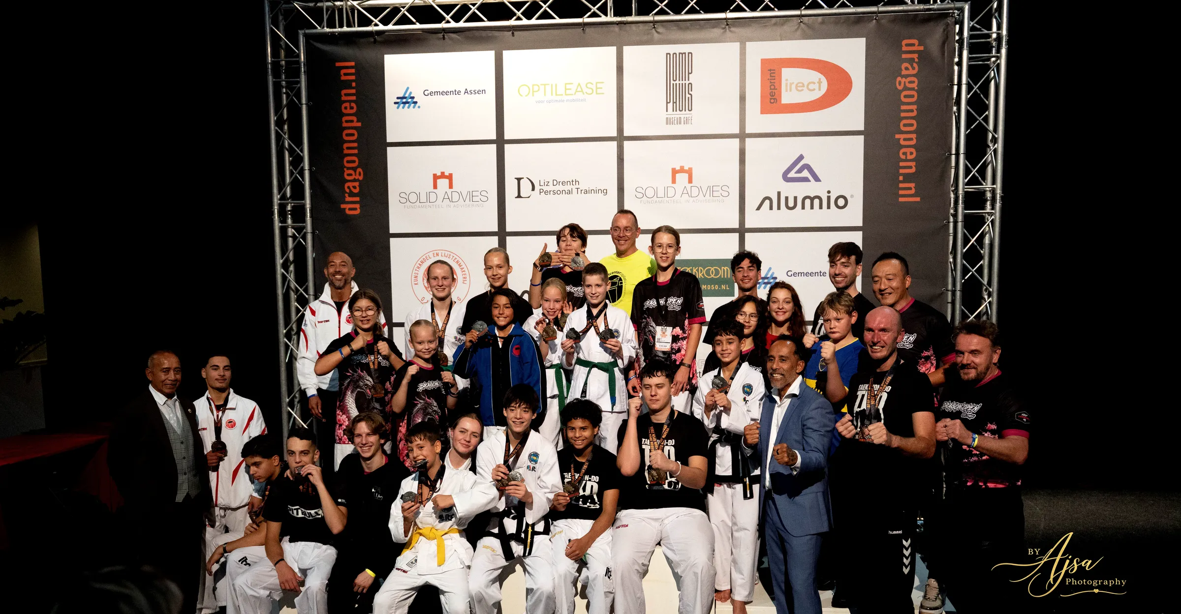 Group photo in front of the sponsor wall