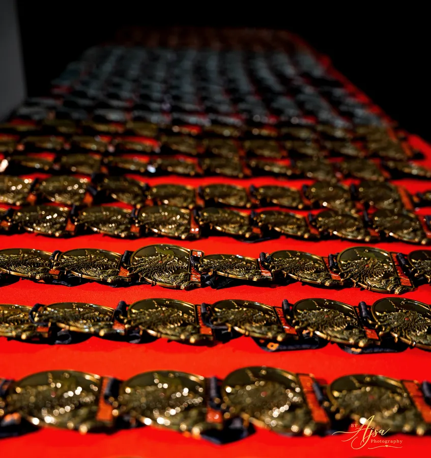 Rows of Dragon Open medals on red cloth