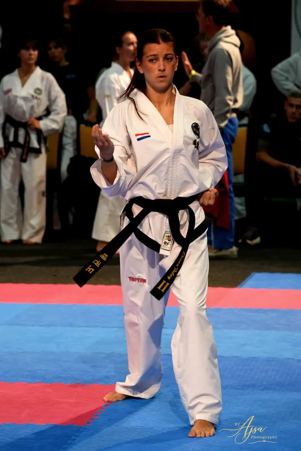 Athlete standing ready on the mat before a pattern
