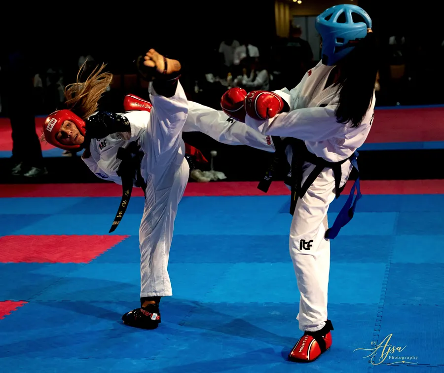 Two competitors trading high kicks in sparring