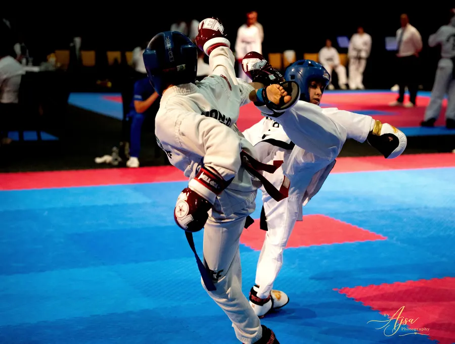 Competitor throwing a high kick in sparring