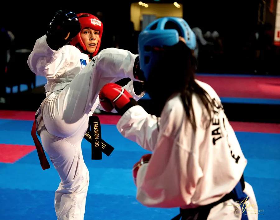 Competitors in red and light blue head guards in sparring